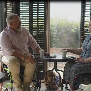 Veterans in civilian clothes at a table having a chat 