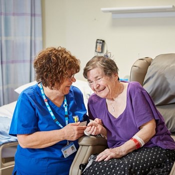 A picture of a staff member talking to a patient