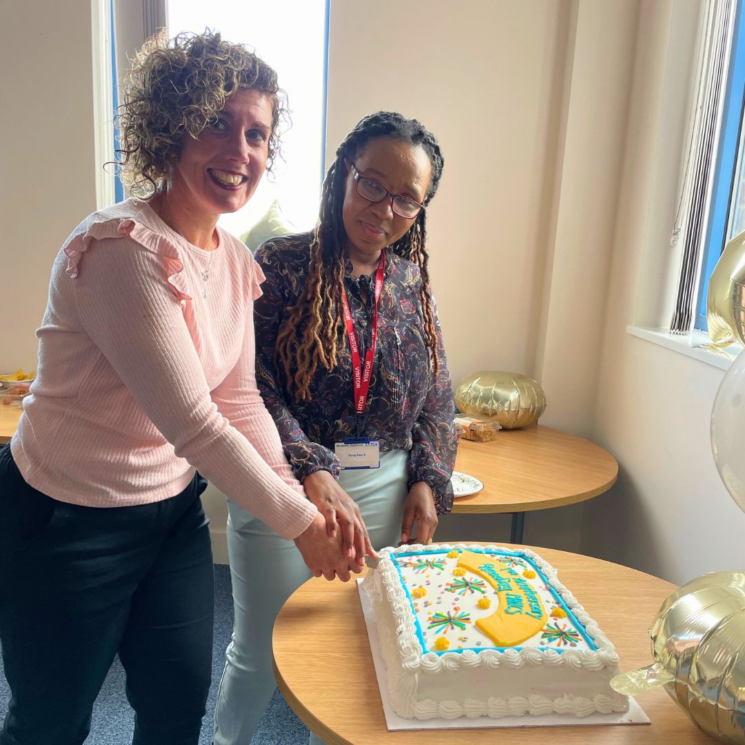 Leanne Ballantyne and Polite Tshuma cutting anniversary cake