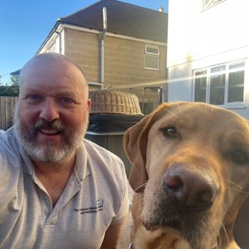 Jon, our armed forces lead, takes a selfie outside on a sunny day with Baxter his assistance dog