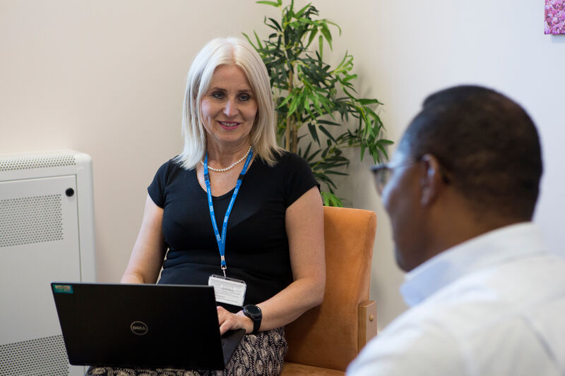 A staff member talking to a patient about feedback