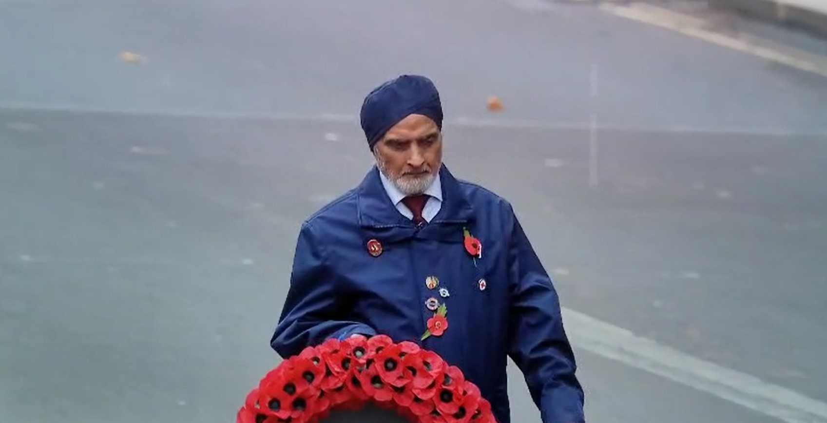 Baldev Sian carrying Remembrance wreath