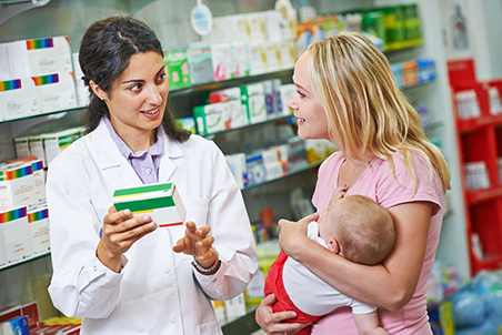 A pharmacist assisting a parent with a small child