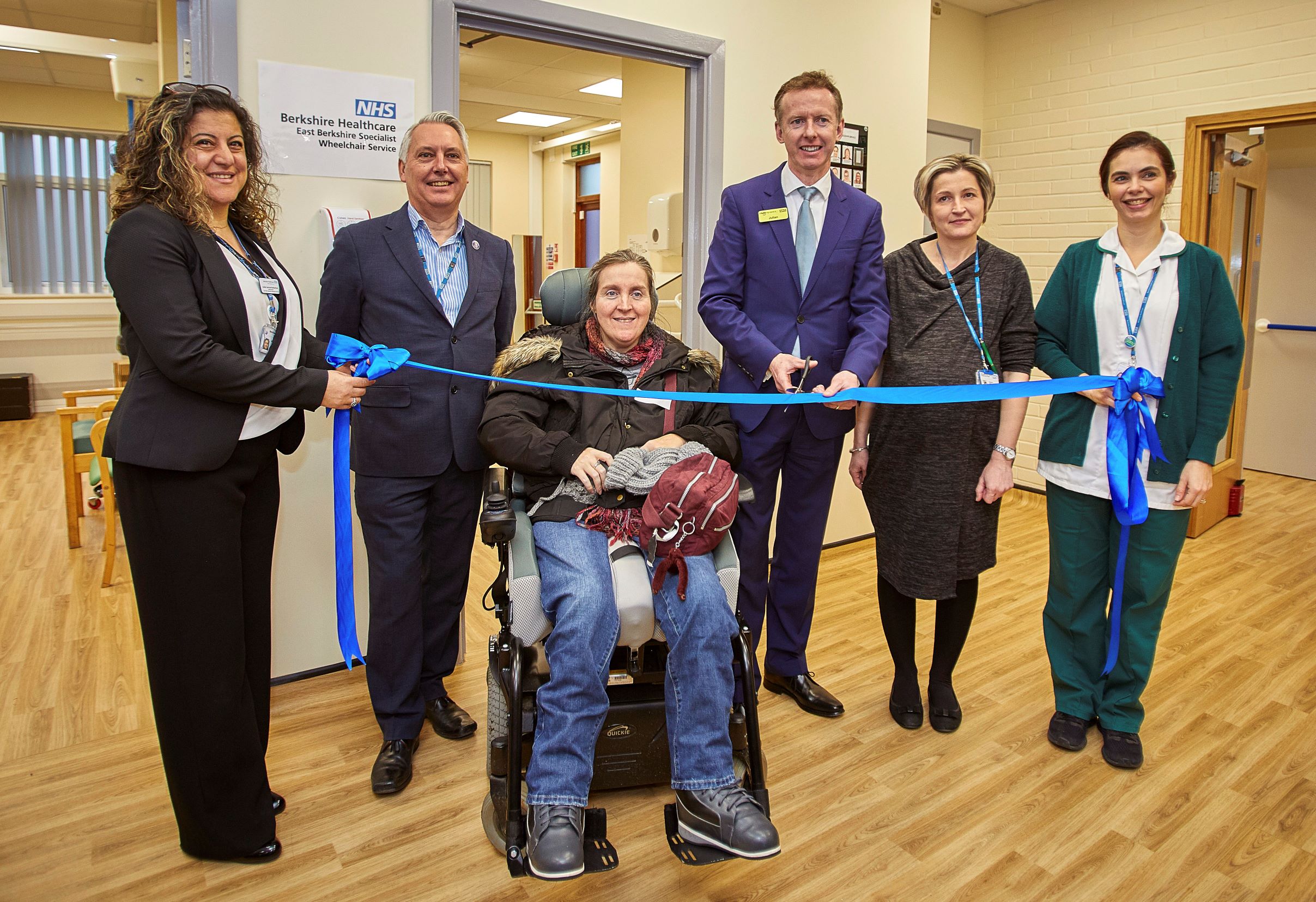 Our CEO Julian Emms with staff and patients cutting the official opening ribbon