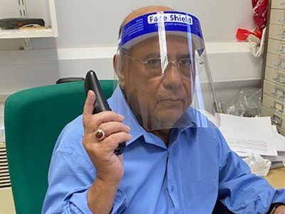Picture of Dr Biru Jha with a face guard