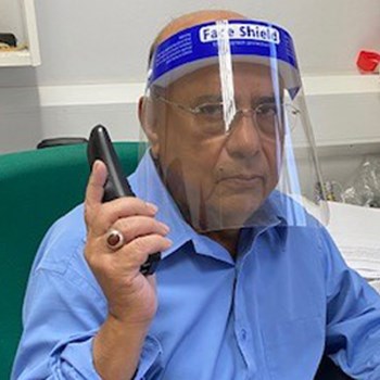 Picture of Dr Biru Jha with a face guard