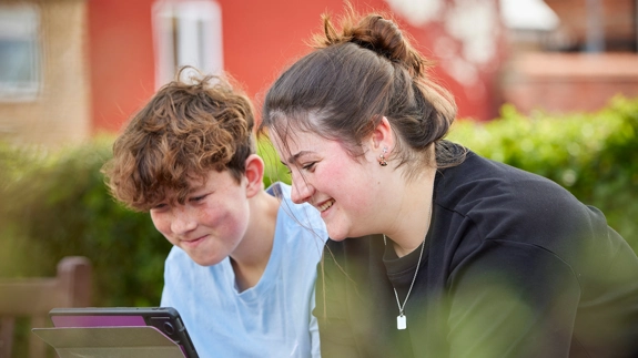 Two young people looking at tablet