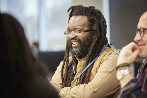 Staff member smiling in a meeting