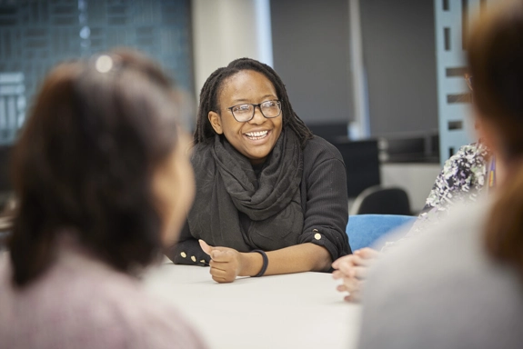 Staff member in office talking in meeting
