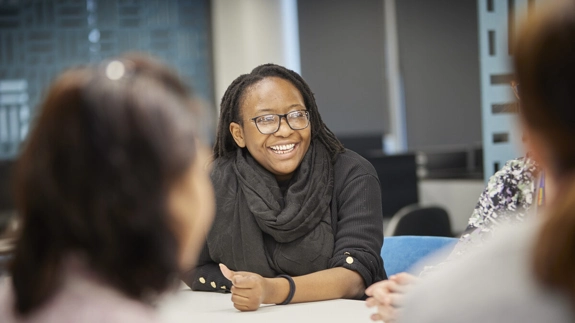 Staff member in office talking in meeting