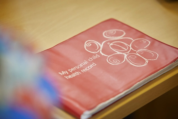 A Personal Child Health Record, also known as a Red Book, on a table