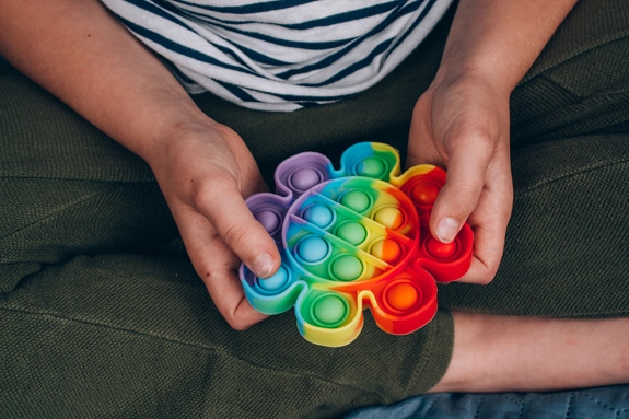 Holding A Rainbow Pop It Sensory Fidget Toy