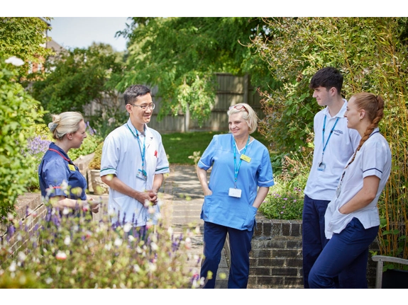 multidisciplinary team meeting outside in a courtyard