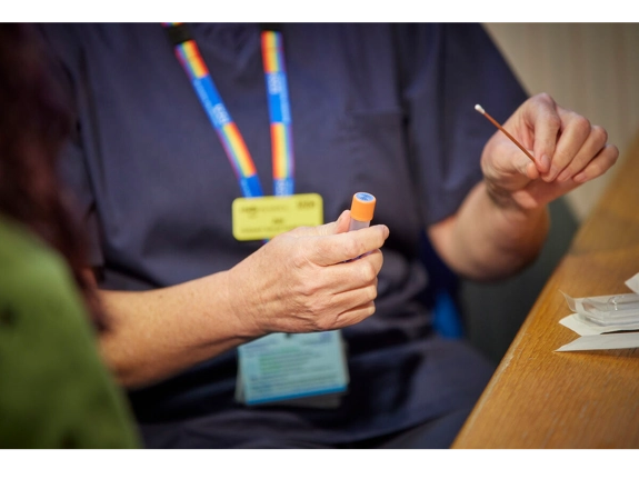 A nurse holding a test swab