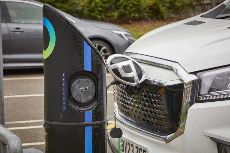 Car plugged into electric charging point